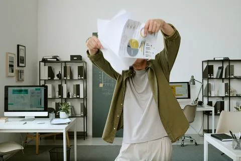 Middle Aged Man Dancing with Financial Documents in Modern Office Stock Photos