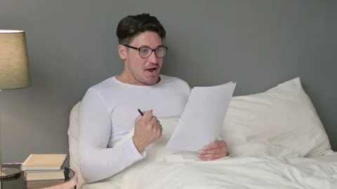 Middle Aged Man with Documents Celebrating Success in Bed 스톡 동영상 142374671