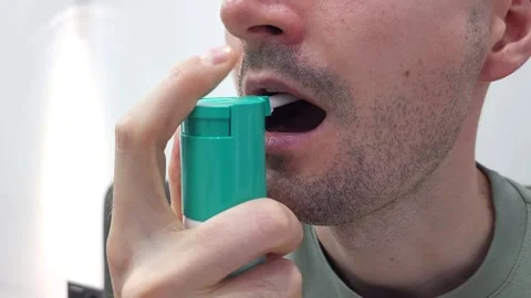 A middle-aged man does an oral inhalation of a drug. Close-up of an open mouth Stock Footage 282610110