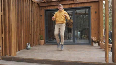 Middle Aged Man Doing Cardio Exercise On Wooden Terrace Near Modern Cabin Stock Footage 335133353