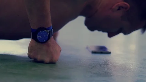 Middle-aged man doing press-ups in a gym Stock-Footage 121451819
