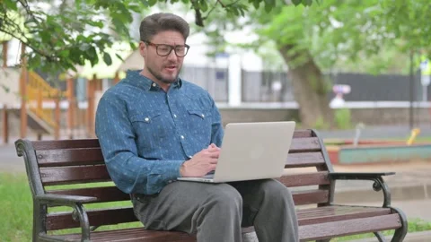 Middle Aged Man Doing Video Call on Laptop in Park 스톡 동영상 311364425