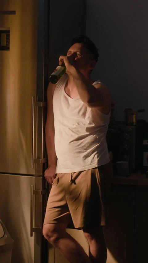 Middle Aged Man Drinking Beer in Kitchen Suffering from Alcohol Addiction Stock Footage 344850841