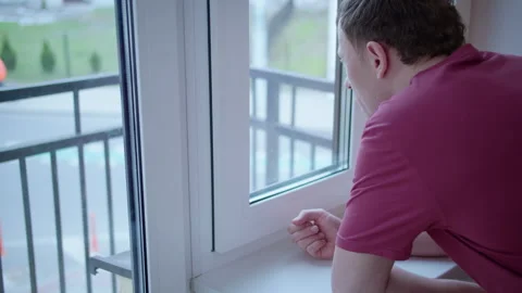 Middle Aged Man Drinking Coffee and Looking Out the Window Stock Footage 329960715