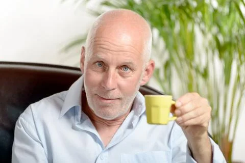 A middle-aged man drinking coffee Stock Photos