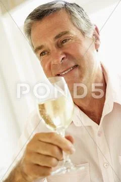 Middle Aged Man Drinking A Glass Of Wine Stock-Fotos