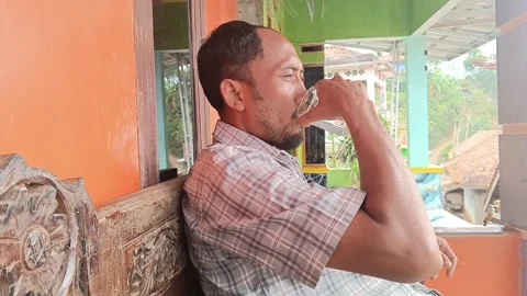 Middle aged man drinking water for healthy lifestyle in rural home Stock Footage 316446519