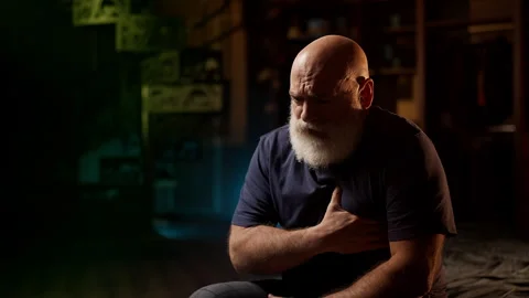 Middle-aged man experiences chest pain, worried about possible heart issue Stock Footage 342520723