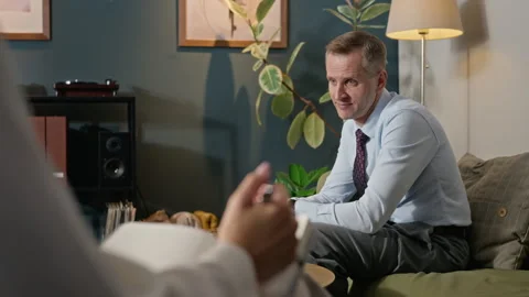 Middle Aged Man Explaining Problems to Psychologist in Therapy Session Stock Footage 340628836