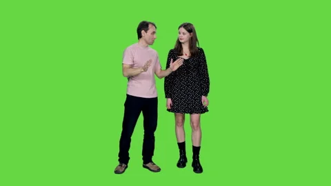 Middle aged man explains something and shows to young woman in polka-dot dress Video stock 243747137