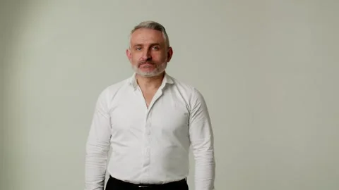 A middle aged man expresses doubts about the correctness of someone else Stock Footage 252880225