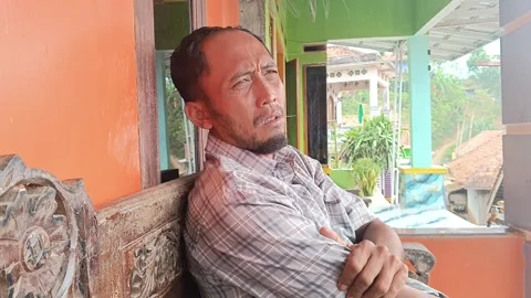 Middle aged man feeling arm pain while sitting outdoors Stock Footage 316444045