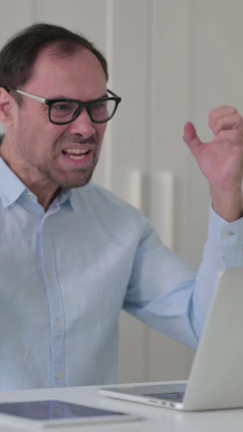 Middle Aged Man Feeling Shocked While using Laptop in Office, Vertical Video 스톡 동영상 339584640