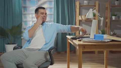 Middle aged man freelancer or office worker procrastinates at work Video stock 150822118