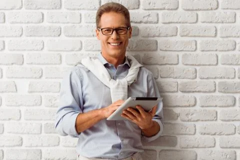 Middle aged man with gadget Stock Photos