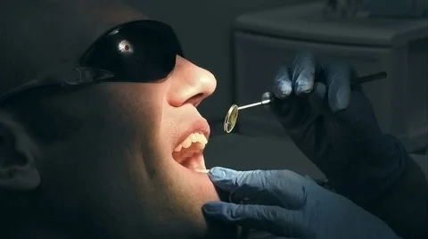 Middle aged man gets dental mouth teeth treatment Stock Footage 64875487
