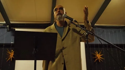 Middle-aged man giving an passionate speech and shouting through a megaphone on Stock Footage 341069243