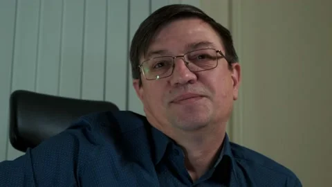 A middle aged man with glasses and a smile in the office Stock Footage 150450798