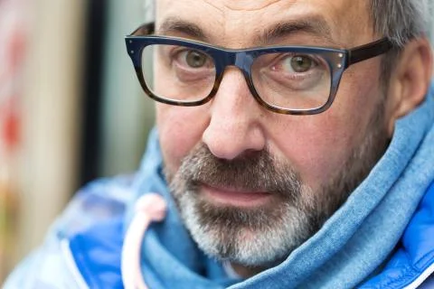 Middle aged man with glasses, beard and modern clothes Stock Photos