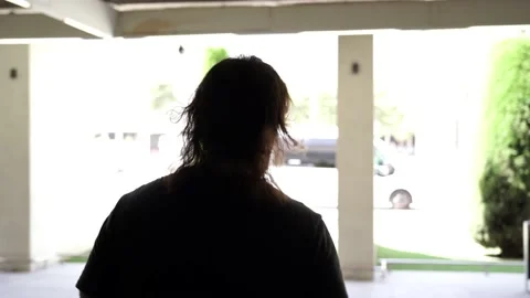 Middle aged man going out from the airport terminal while wearing a mask for  Video stock 136393566