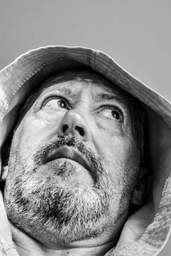 Middle aged man with gray beard wearing bathrobe Stock Photos