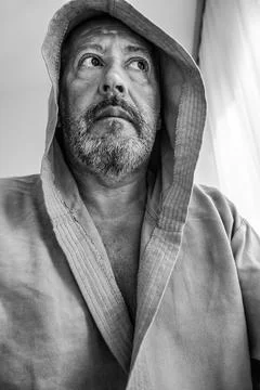 Middle aged man with gray beard wearing bathrobe Stock Photos