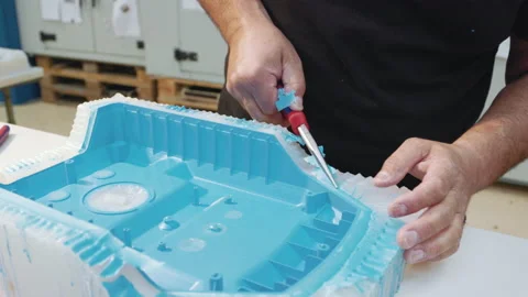 Middle aged man hands working with tool manufacturing vacuum cleaner shell Stock Footage 143557256