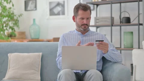 Middle Aged Man having Fail Online Shopping Experience on Laptop in Lap Stock Footage 287897748