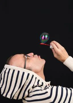 Middle aged man having fun blowing soap bubbles Stock Photos