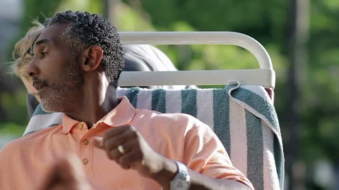 Middle-aged man having his chair moved. 스톡 동영상 88368122