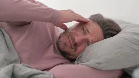 Middle Aged Man having Migraine while Lying on Side in Bed Video stock 287409759