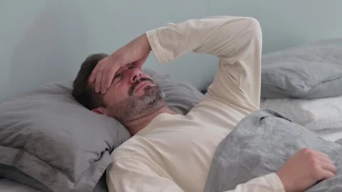Middle Aged Man having Migraine while Sleeping in Bed Stock Footage 287899214