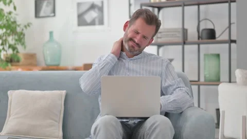 Middle Aged Man having Neck Pain with Laptop in Lap Stock Footage 287898077