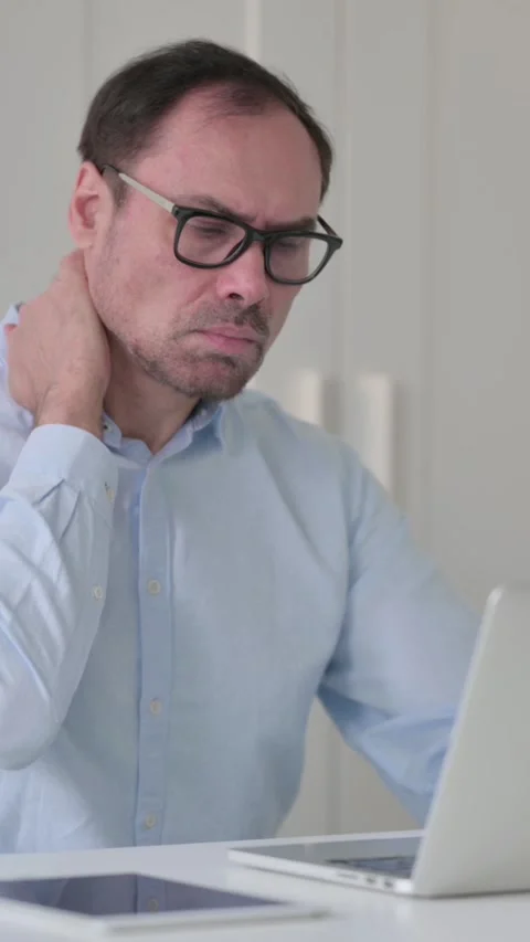 Middle Aged Man having Neck Pain while Typing on Laptop, Vertical Video 스톡 동영상 339584458