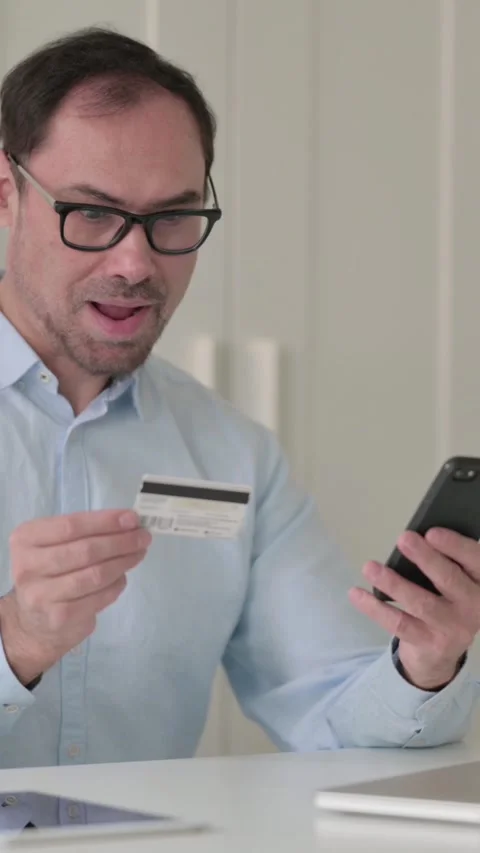 Middle Aged Man having Online Payment Success on Smartphone, Vertical Video 스톡 동영상 339585004