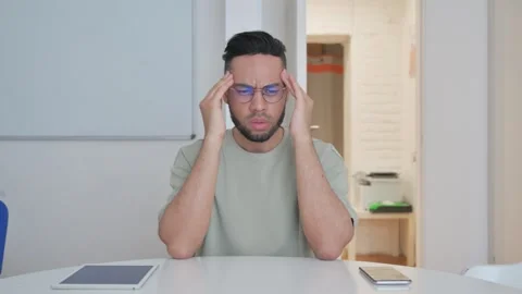 Middle Aged man with Headache Sitting at Work 動画素材 307916967