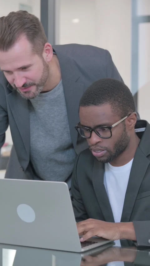 Middle Aged Man Helping African Teammate on Laptop, Standing, vertical video Stock-Footage 324696722