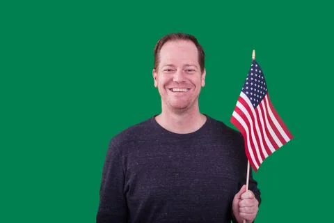 Middle aged man holding a American flag on green screen background Stock Photos