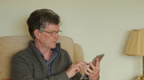 Middle aged man at home using tablet Stock Footage 33211267