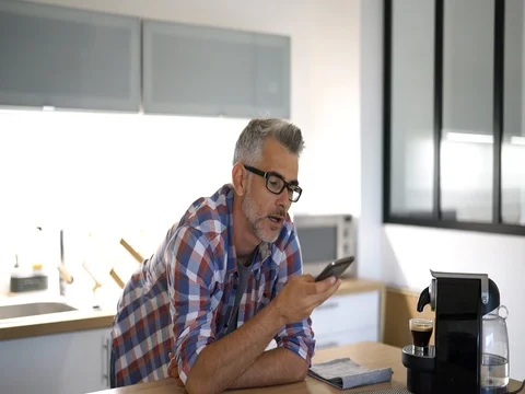 Middle-aged man at home using smartphone Stock Footage 81727991