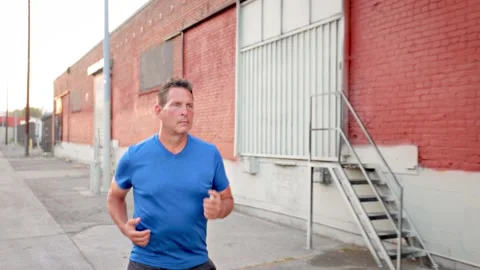 Middle-aged man jogging to get back into shape Video stock 220022251
