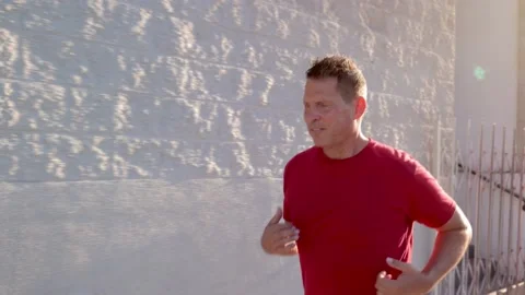 Middle-aged man jogging to get back into shape Video stock 220022345