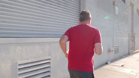 Middle-aged man jogging to get back into shape 動画素材 220959726