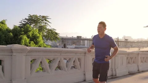 Middle-aged man jogging to get back into shape 스톡 동영상 239858079