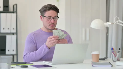 Middle Aged Man with Laptop Counting Dollar in Office Video stock 143566118