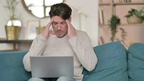 Middle Aged Man with Laptop having Headache at Home 스톡 동영상 142378686