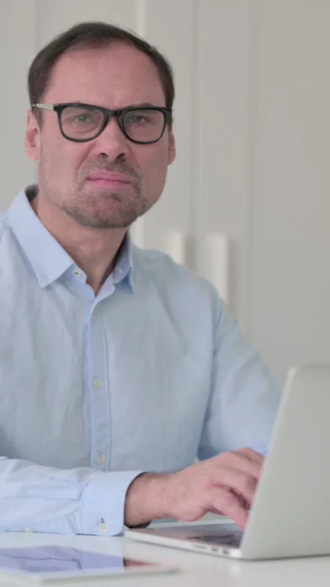 Middle Aged Man with Laptop Shaking Head as No Sign, Vertical Video 스톡 동영상 339584873