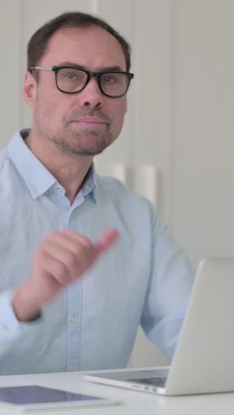 Middle Aged Man with Laptop Showing Thumbs Down Sign, Vertical Video 스톡 동영상 339584849