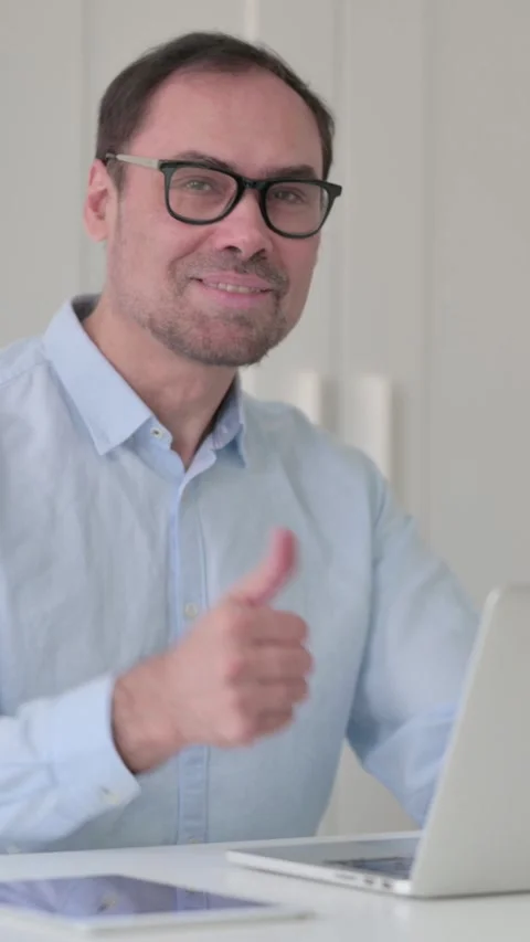 Middle Aged Man with Laptop Showing Thumbs Up, Vertical Video 스톡 동영상 339584852