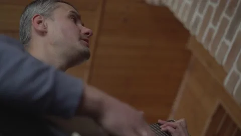 Middle aged man learning play acoustic guitar at home during lockdown. Stock Footage 164549250